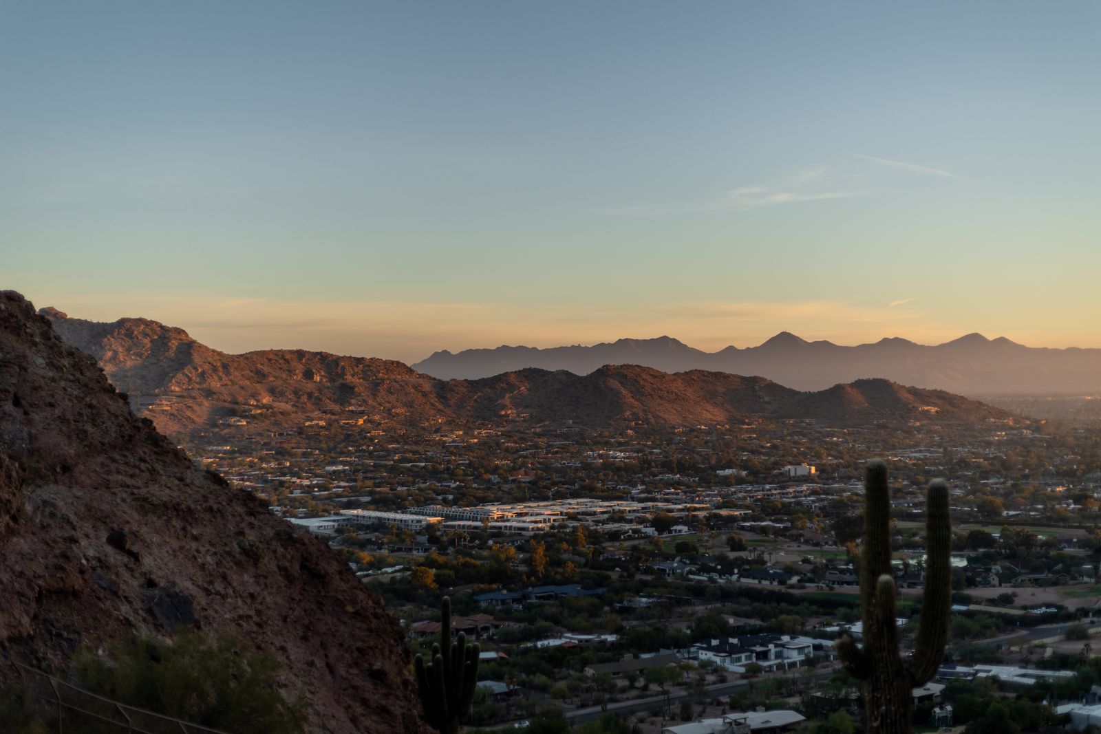 View over Phoenix neighborhoods and desert mountains at sunset